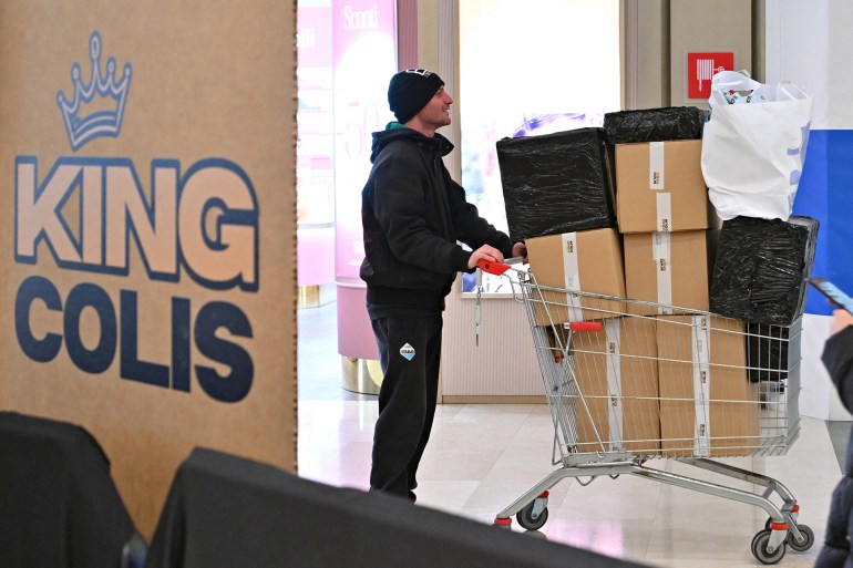 A man leaves with secret packages he purchased at the pop-up store King Colis, a French start-up that organizes sales of lost parcels from e-commerce platforms like Amazon, at the Roma Est shopping center, on January 17, 2025. People donít know the content of the package until the moment of the purchase. Once theyíve identified the parcel they want they go to the scales and pay ìby weightî (1.99 euros per 100 grams for generic ones, 2.79 euros for Amazon ones). (Photo by Andreas SOLARO / AFP)