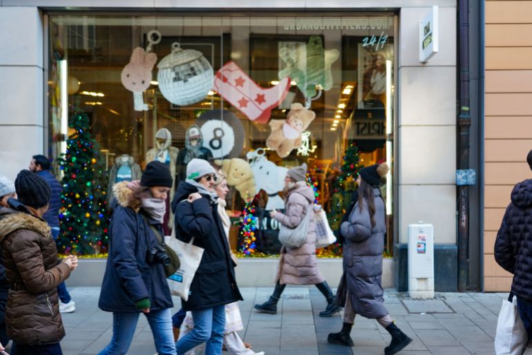 A bustling shopping street in Munich, Bavaria, Germany, on November 30, 2024, is alive with the festive spirit as shoppers fill the streets, admire holiday decorations, and select Christmas gifts. The atmosphere is lively, with a sense of excitement for the upcoming holidays. Kaufinger Strasse in Munich is crowded as many people are out shopping for Christmas gifts. The store windows are decorated with festive displays, showcasing a wide range of gifts and holiday items. Passersby stop to admire the windows and choose presents for the upcoming holiday season. Numerous Christmas stalls in the middle of the street invite people to drink mulled wine or eat snacks. As one of Munich's central shopping streets, Kaufinger Strasse attracts both locals and tourists who are completing their pre-Christmas shopping. The festive atmosphere is enhanced by the Christmas decorations and the increasing number of shoppers in the stores. The street becomes a lively spot for those looking to buy gifts and experience the holiday spirit.