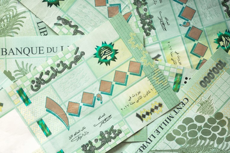 Group of 100 000 Lebanese pounds bills randomly scattered - currency of Lebanon المصدر : أدوبي ستوك