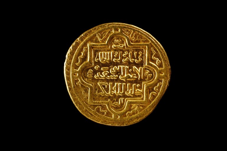 Ancient golden islamic coins isolated on black, closeup. ilkhanid empire coin