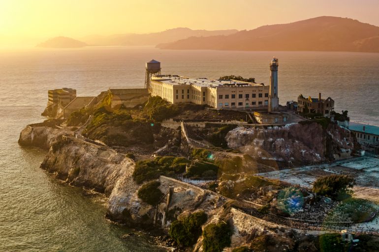 Aerial view of prison building on Alcatraz Island during sunset, San Francisco Bay, California, USA.